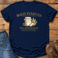 A navy blue graphic t-shirt featuring a sourdough starter, yeast and a vintage-style cream print that reads 'WILD YEAST CO. EST.